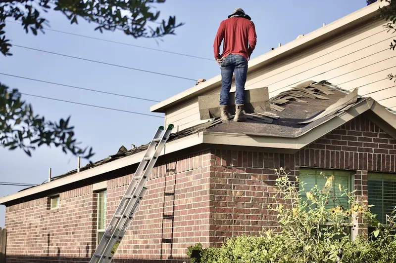 Professional roofer working on a residential roof in Creek Point